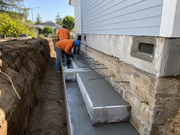 New foundation footing poured and tied into an existing home's foundation