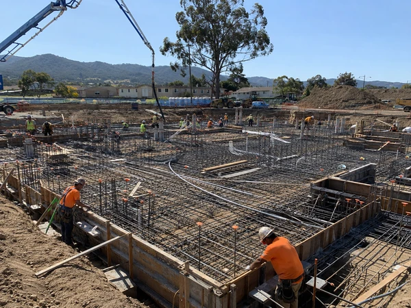 Large-scale poured concrete foundation with extensive rebar for a commercial building project