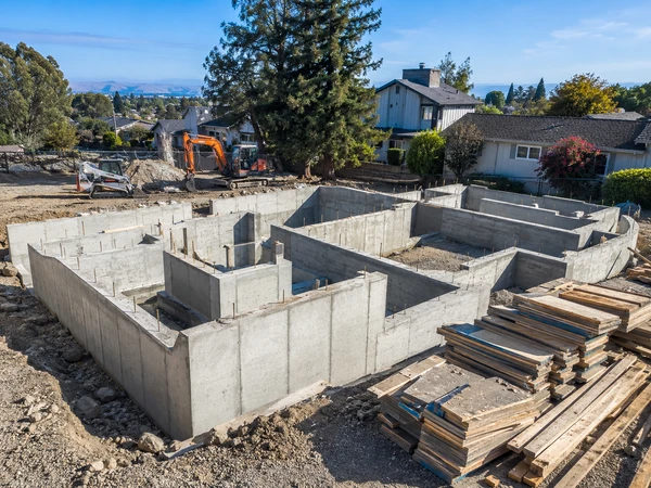 Completed poured concrete stem wall foundation ready for framing on a new home lot